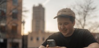 a man sitting at a table looking at his cell phone