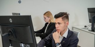a man sitting at a desk in front of a computer