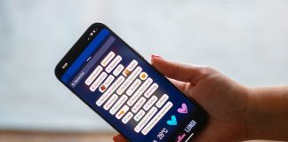 A person holding a cell phone in their hand