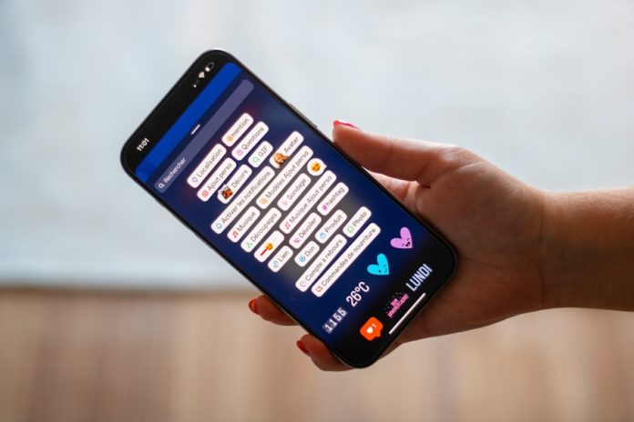 Photo by Swello A person holding a cell phone in their hand