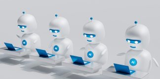 a group of white robots sitting on top of laptops