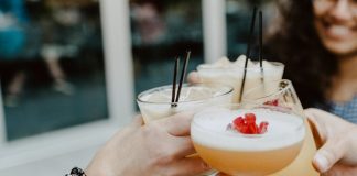 person holding filled drinking glasses