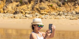 a woman taking a picture of herself in the water