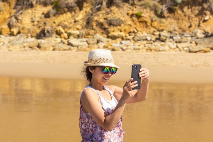 a woman taking a picture of herself in the water
