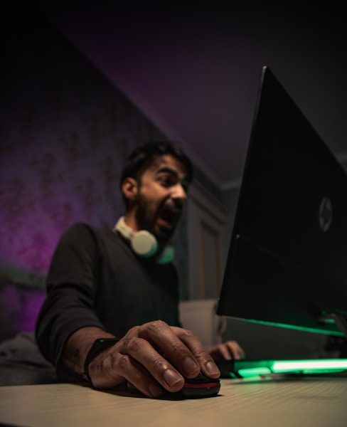 Photo by Akram Huseyn man in black long sleeve shirt holding black laptop computer