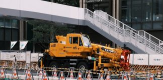 a large yellow truck parked in front of a building