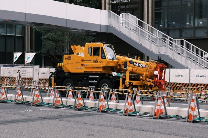 a large yellow truck parked in front of a building