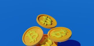 three gold bitcoins sitting on top of each other