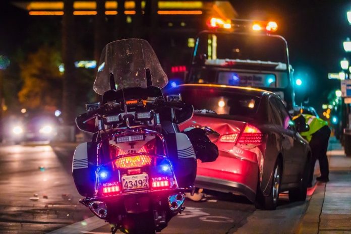 Photo by Matt C policeman leaning on sports car's window