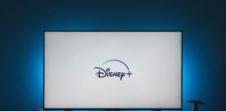 a flat screen tv sitting on top of a wooden table