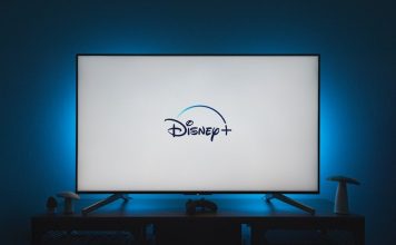 a flat screen tv sitting on top of a wooden table
