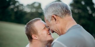 two man talking to each other on grass field