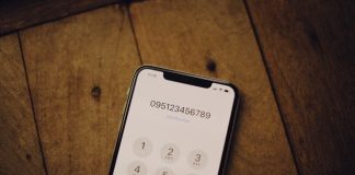 a cell phone sitting on top of a wooden table