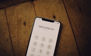 a cell phone sitting on top of a wooden table