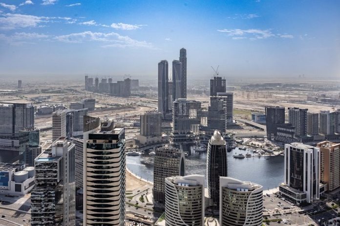 Photo by Nelemson Guevarra An aerial view of a city with tall buildings