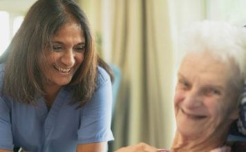 Important Considerations for Opening a Care Business in Your Community Nurse smiling with elderly patient in room
