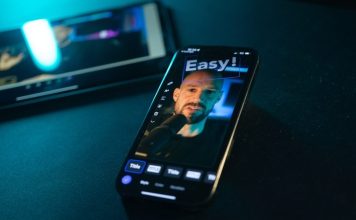 Smartphone displaying a man's face with "easy!" text.