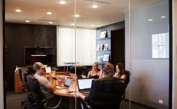 When “Good Enough” Hiring Starts Costing Your Business people sitting near table with laptop computer