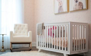 A cozy nursery with a white crib and armchair.