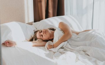 The Biggest Sleeping Mistake After Breast Augmentation a person lying in a bed