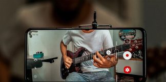 man in white crew neck t-shirt playing electric guitar