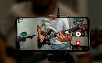 man in white crew neck t-shirt playing electric guitar