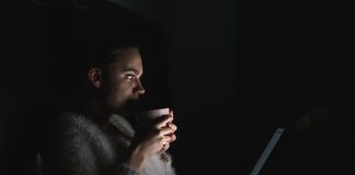 a person sitting in front of a laptop