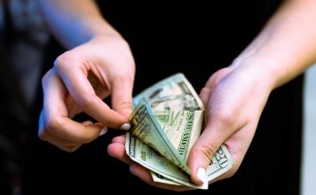 Get Instant Cash Loan in 2 Minutes with an Easy Process and Minimal Documentation person holding fan of 100 us dollar bill