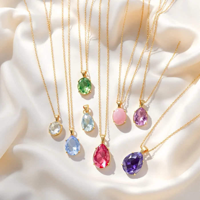 Flat-lay of birthstone pendant necklaces in different gemstone colors