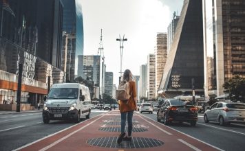 What First-Time Visitors Should Know Before Exploring a New City? photography of woman walking in between road with vehicles