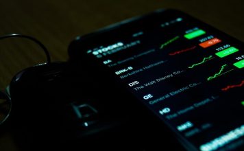 JQK Malaysia Review: Everything You Need to Know Before Joining smartphone on brown wooden surface