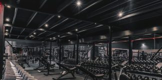 a gym filled with lots of machines and weights