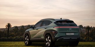 a green suv parked in a grassy field