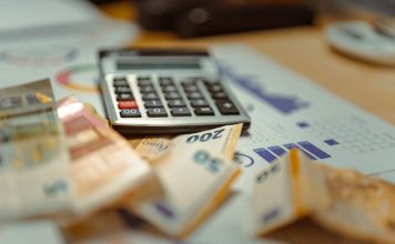 Investment Tax Credit Basis Reduction: Why Your Depreciable Amount Drops by Half the Credit A calculator sitting on top of a pile of money
