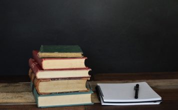 How School Mentoring Can Help Students Navigate Academic Challenges pile of books beside white printer paper and black ballpoint pen