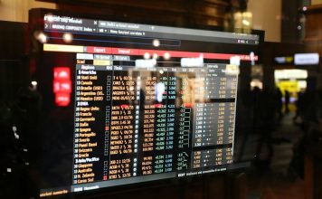 Same Stock, Two Exchanges: Why Do NSE and BSE Prices Sometimes Differ? Financial stock market data displayed on a screen