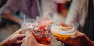A group of people holding drinks in their hands