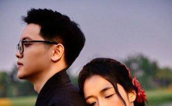 Young couple in kimonos embracing outdoors at dusk