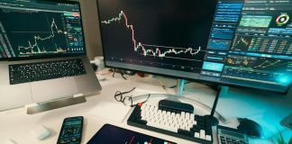 Stock charts are displayed on multiple screens