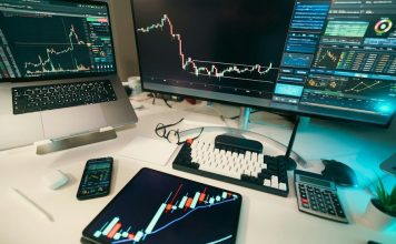 Stock charts are displayed on multiple screens