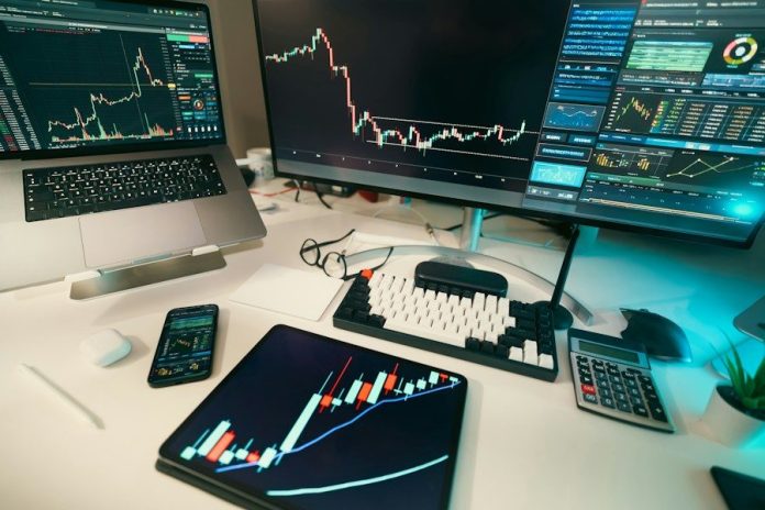 Stock charts are displayed on multiple screens