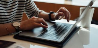 person seated at the table using laptop