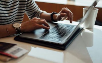 person seated at the table using laptop