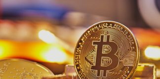 a bit coin sitting on top of a pile of coins