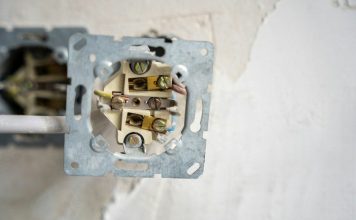 Smart House Wiring: A Practical Guide for Modern Homes Electrical outlet disassembled, revealing the wiring