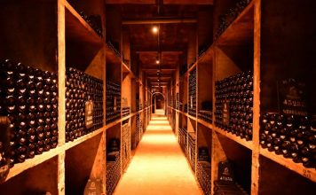 A long narrow room filled with lots of bottles
